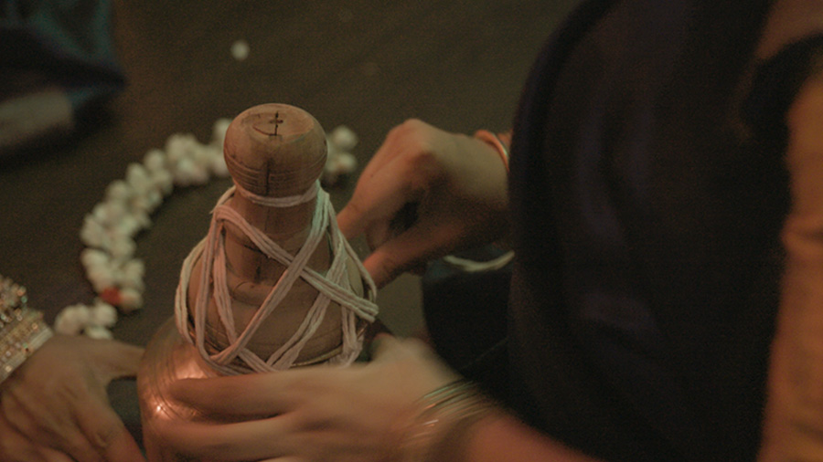 The tying of a Karagam by performing artists.